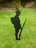 Black metal silhouette of soldier with backpack, gun and helmet solemnly looking down in respect of their fallen comrades. Made from strong 2mm thick metal and finished in a rust proof silk paint.