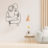 A minimalistic metal line art beautifully designed and cut show a couple embracing in a hug.
