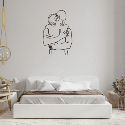 A minimalistic metal line art beautifully designed and cut show a couple embracing in a hug.  