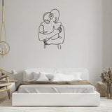 A minimalistic metal line art beautifully designed and cut show a couple embracing in a hug.  