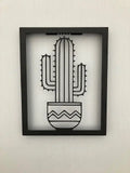 Metal wall art of a cacti in a frame, creates a fantastic 3D effect on the wall behind