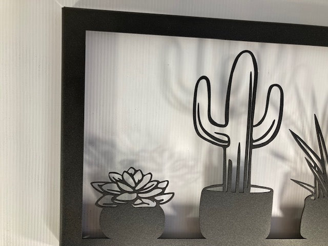 Metal wall decor showing five types of cacti in a frame, cut with great detail and gives a 3D effect on the wall behind, makes a great gift