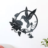 Metal wall decor of a hummingbird hovering above an open flower